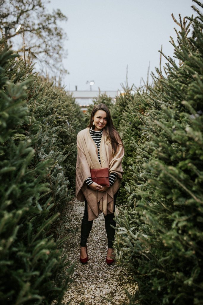 Alpaca cape over a striped turtleneck - get into the holiday spirit with layering in your outfits! 