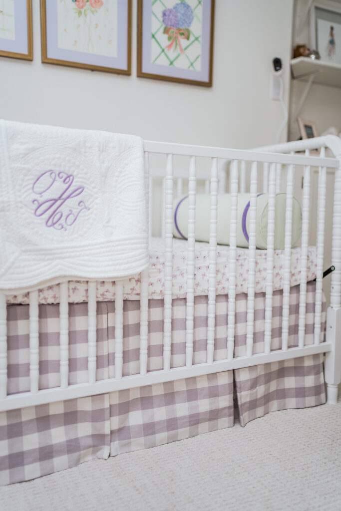 DaVinci Jenny Lind 3-in-1 white crib with Schumacher gingham lilac fabric crib skirt for baby girl nursery | Adored by Alex