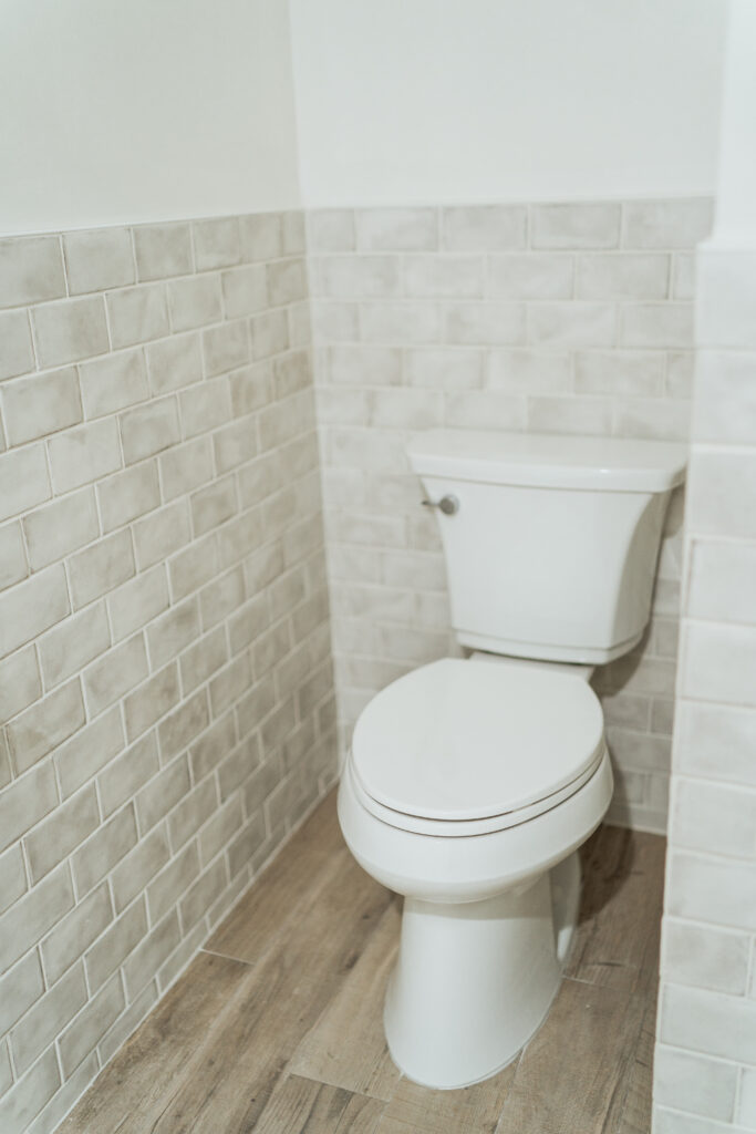 Grey subway tile wainscoting for a small bathroom and water closet | Adored by Alex